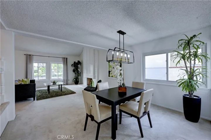 Your view from the kitchen to the formal dining and living rooms. Note the gas starter fireplace in the living room.