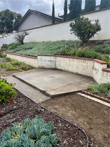 Spacious cement pad in the backyard for alfresco dining.