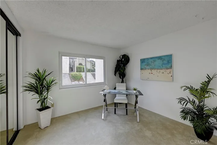 The spacious downstairs bedroom has mirrored wardrobe doors.