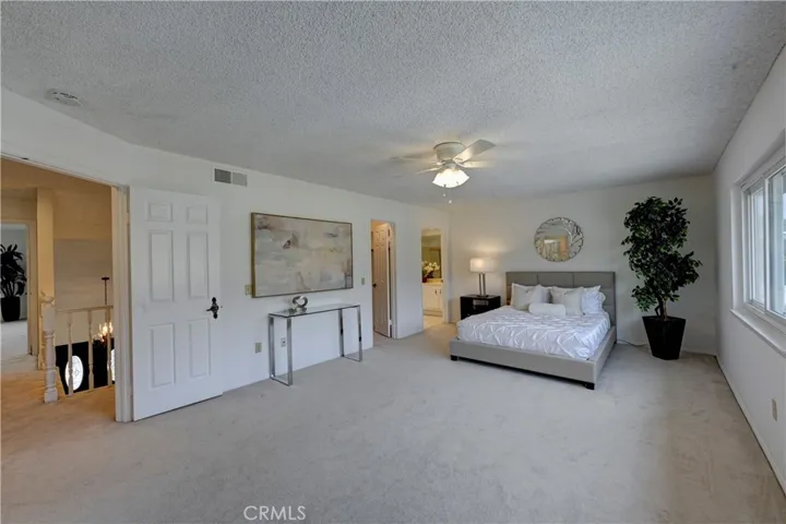 The ensuite primary bedroom has a double door entry, walk in closet as well as a floor to ceiling closet behind us in this photo.