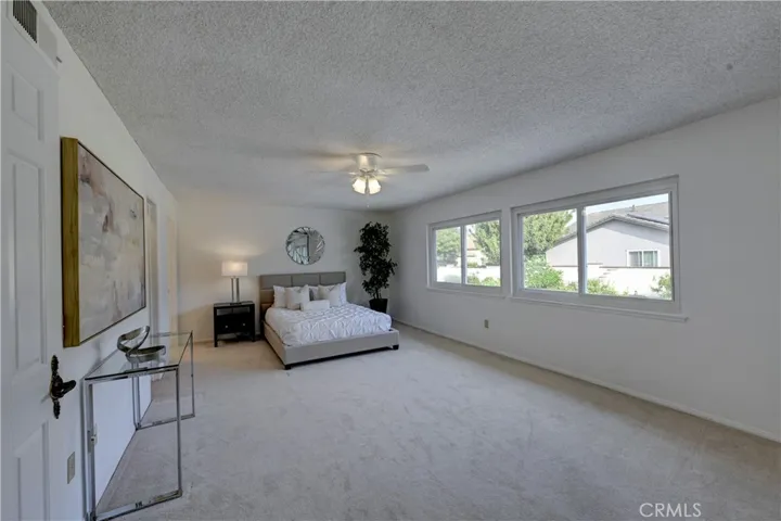 Huge primary ensuite bedroom with lighted ceiling fan and lots of natural light too.