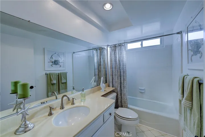 Upstairs full bath with window and recessed lighting.