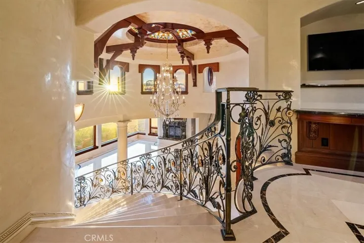 Foyer into the primary suite, complete with TV-- never miss a moment!