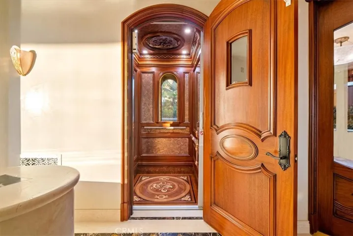 Elevator access near the Upstairs Primary Suite takes you down to the lower levels