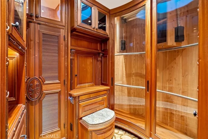 Closet in the upstairs primary, complete with dumbwaiter, and automated closet poles.