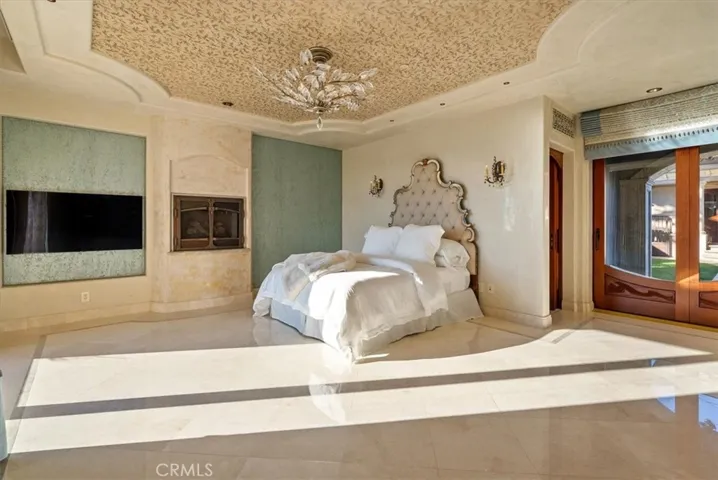 Sliding door entry off the courtyard into the Primary, there is also an outdoor fireplace off this bedroom.