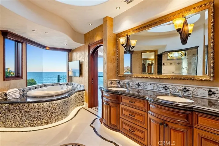 Double sinks, heated marble floors and surfaces, including the tub deck.