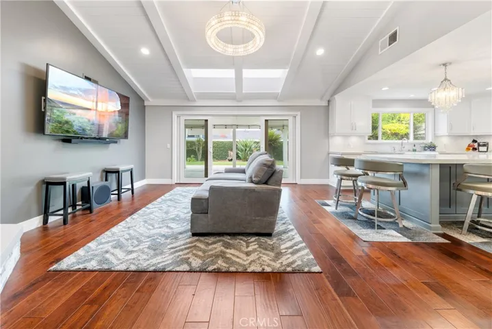 Natural lighting pours through 4 panel glass slider and overhead skylights to brighten this Dining/Family Room