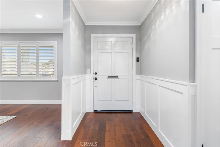 The beauty continues when you walk in and find sexy chocolate tones in this gorgeous Lux-V-Wood Flooring that really compliment the crisp clean lines & brilliant white of the wainscoting, crown molding, doors & trim work!