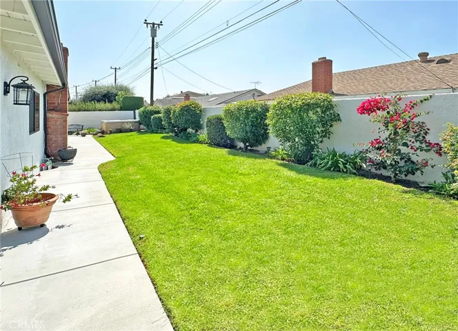 Private backyard with automatic sprinklers for easy landscaping maintenance.