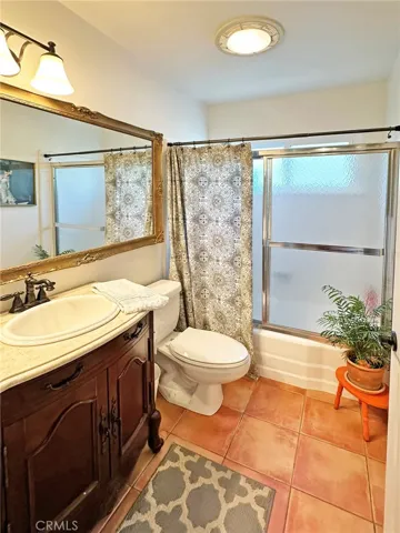 Guest bath has full bath/ shower and an elegant specialty vanity.