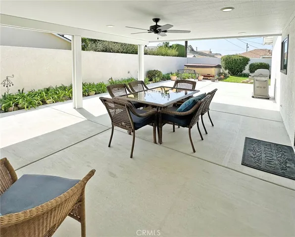 Large Covered outdoor patio with recessed LED lighting and ceiling fan off kitchen dining area for fun and easy entertaining in private yard.