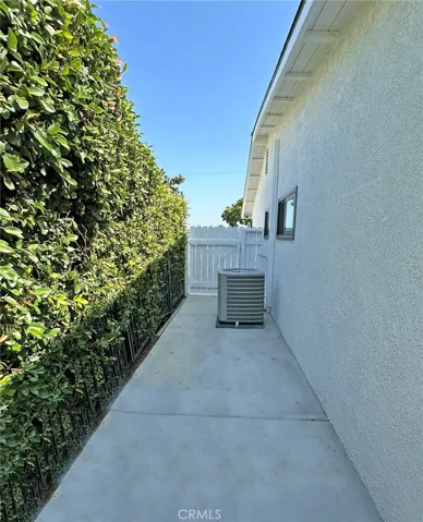 Paved back side yard offers private storage space and is gated for easy access from paved front area.