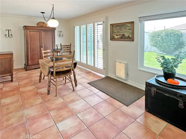 Custom plantation shutters and large windows with custom casements highlight dining room that leads to beautiful backyard.