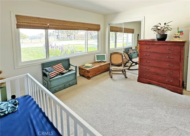 Third bedroom with mirrored door closet, custom black out shades, and large dual pane window.