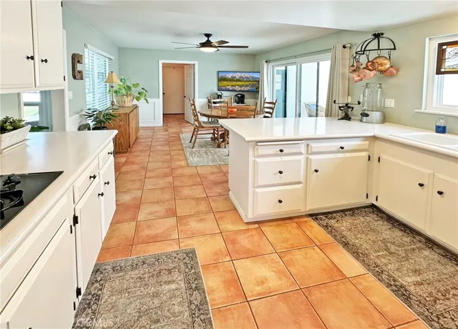 Sizable kitchen and dining area that opens to covered entertaining area in wrap around back yard.  Kitchen has breakfast bar counter for extra seating and work space.  Large dual pane windows and sliding doors offer wonderful natural light.