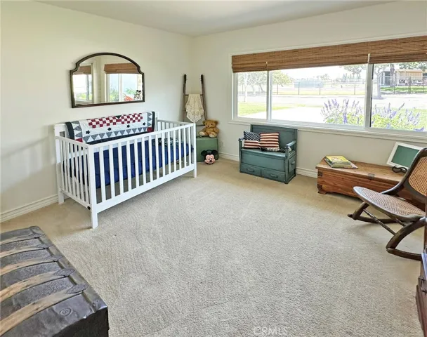 Third bedroom has custom black out shades and dual pane windows that showcase beautiful landscaping that attract butterflies and hummingbirds.