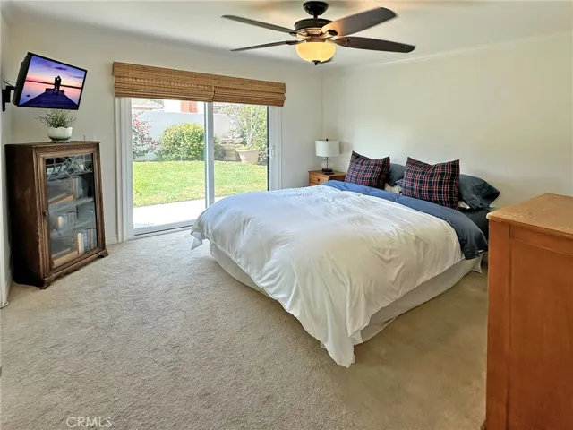 Primary suite has been upgraded with dual pane sliding door leading to private backyard area with fountain. Custom blinds and custom door casings surround the sliding door.  The on-suite bath has new vanity, new   lighting, and a tiled shower.