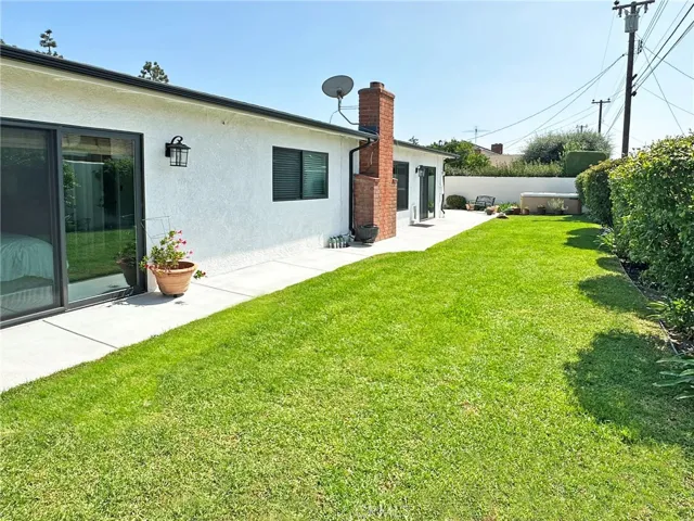 Total of three dual pane sliders lead from home to the private and well-maintained wrap around yard, complete with automated sprinkler system, all new drainage system, large spa, fountain, and covered entertaining wide side yard area.