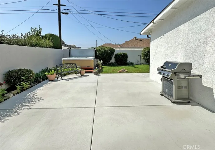 Side yard leading to large spa and fully landscaped backyard