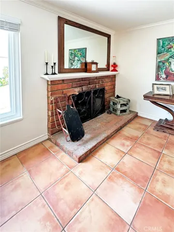Cozy brick Fireplace in Livingroom is highlighted by pristine white mantel.