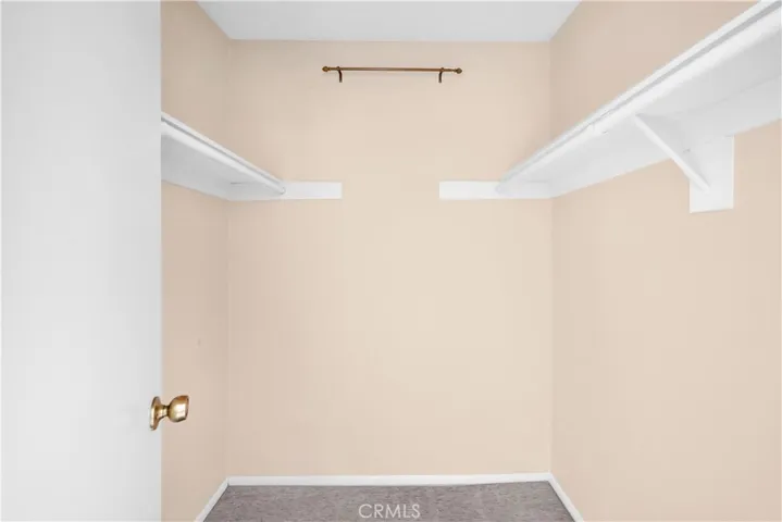 Primary bedroom walk-in closet