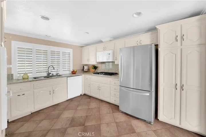 Wood Shutters and plenty of storage in this kitchen