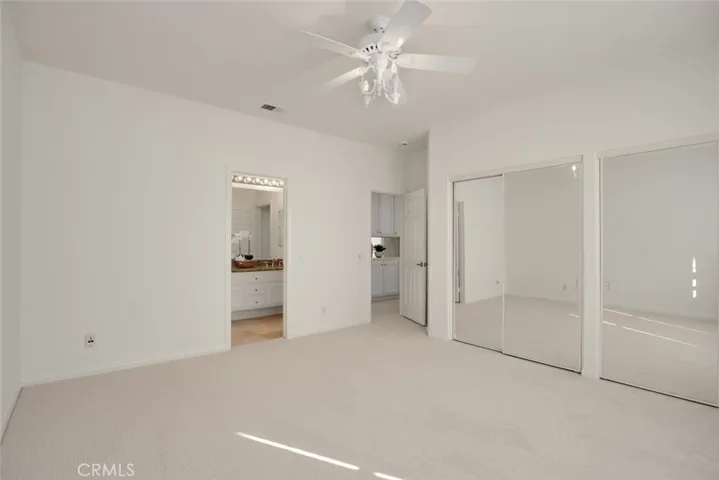 Large 4th bedroom with mirrored closet doors and attached bath
