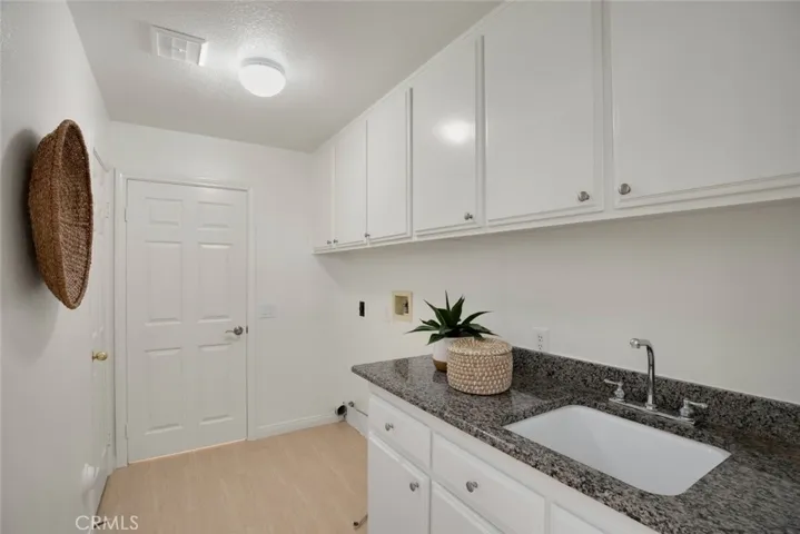Indoor laundry room with sink