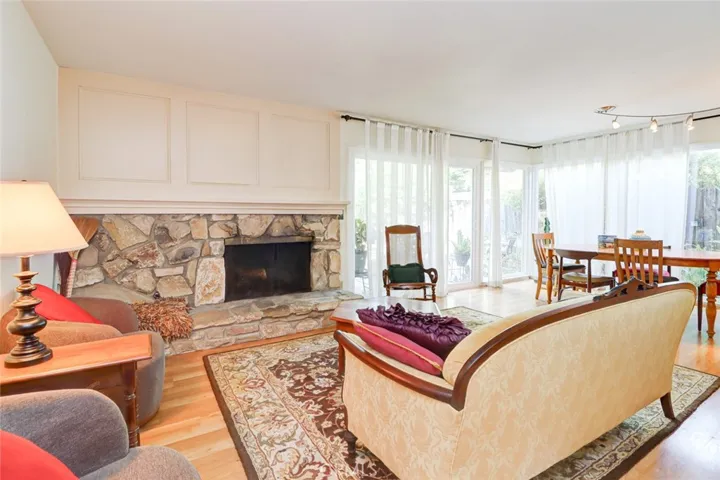 Spacious living room/dining room with manly wood-burning fireplace