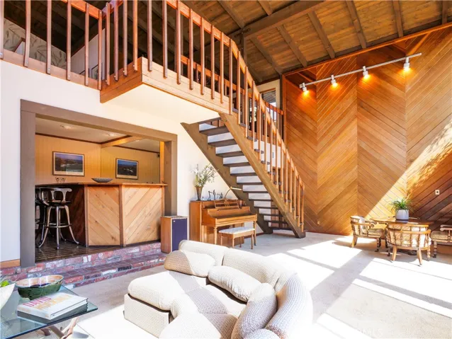 Stairway to downstairs entertainment area with wet bar, family room and bed and bath with sauna
