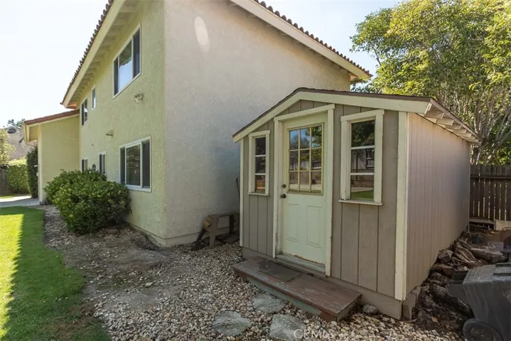 The shed provides extra outdoor storage.