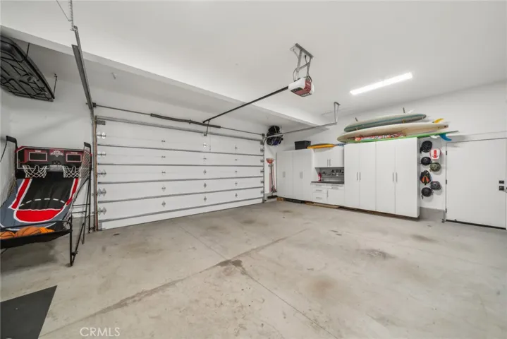 Incredible garage space that fits two full-sized SUVs easily, with plenty of room for storage and an exterior door to the side yard/ dog run. 9' high garage door.