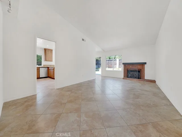 Large Living room area with fireplace and access to outside.