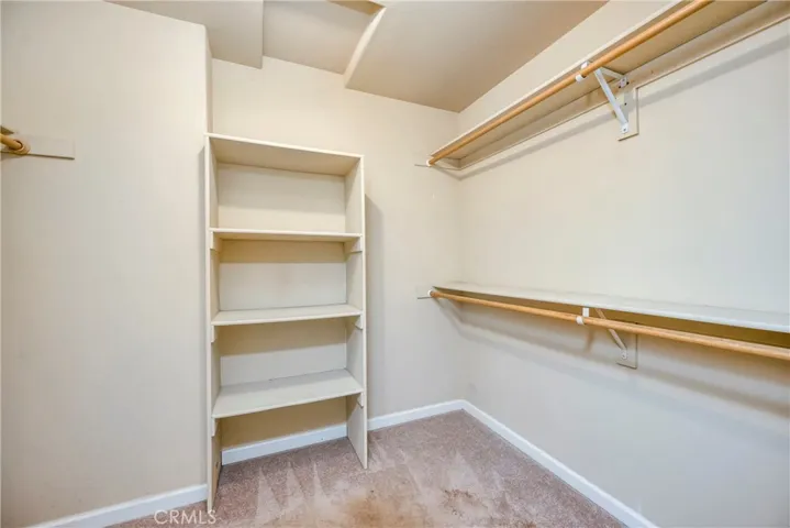 Primary bedroom walk in closet