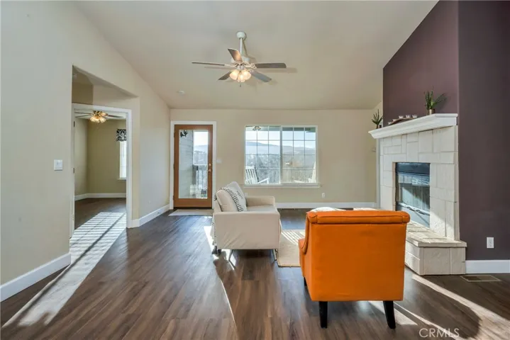 Living room with wood burning fireplace and beautiful views.