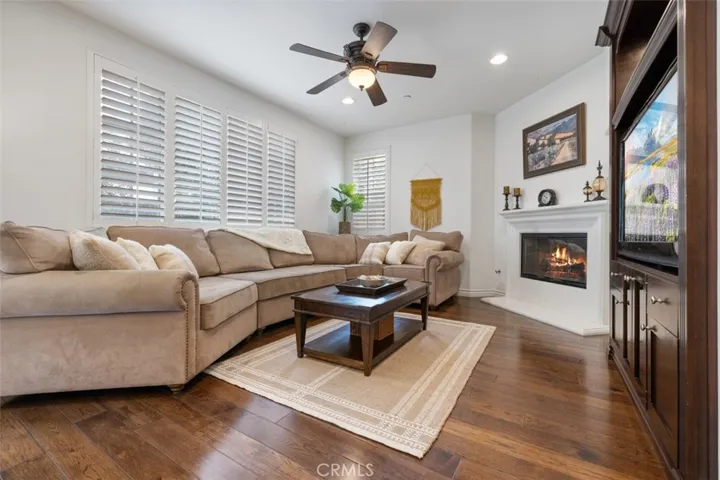 Cozy living room with fireplace and mantle and built in entertainment center.