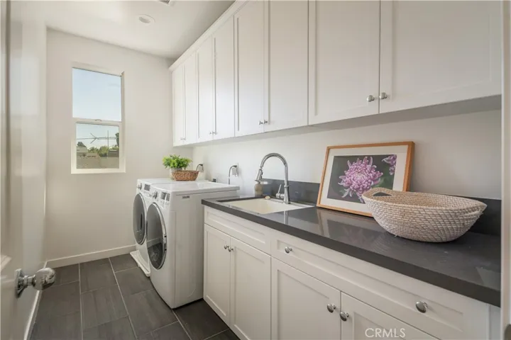 Upstairs laundry with sink & storage