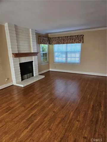 Large living room off the front door entry with a fireplace.