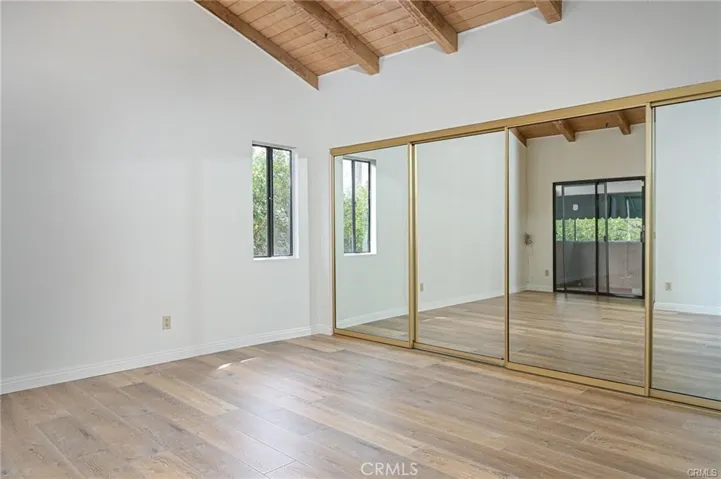 Primary Bedroom with Vaulted Ceilings and mirrored closet
