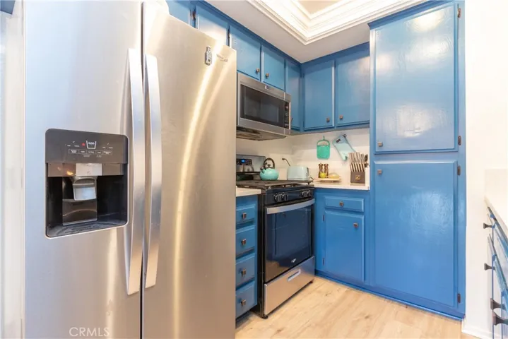 Pantry cupboards and recessed lighting in kitchen.