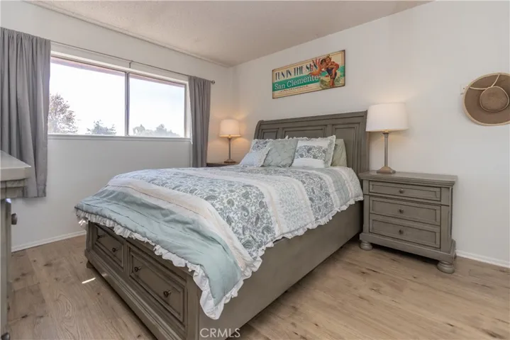 Primary bedroom with large windows.