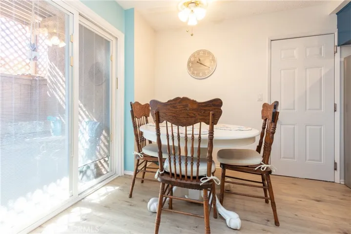 Sunny dining area with door to attached garage.