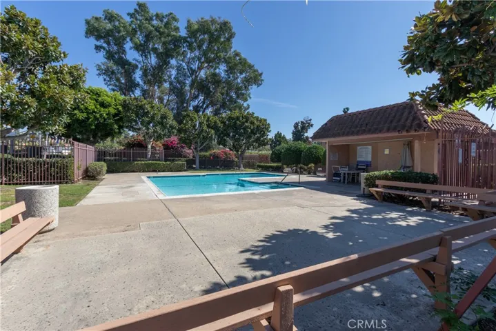 Gated community pool with areas to sun and relax