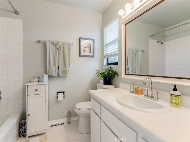 Bathroom includes updated vanity, tile and shower in tub.