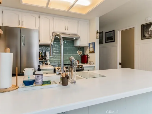 Photos showing kitchen from breakfast bar.