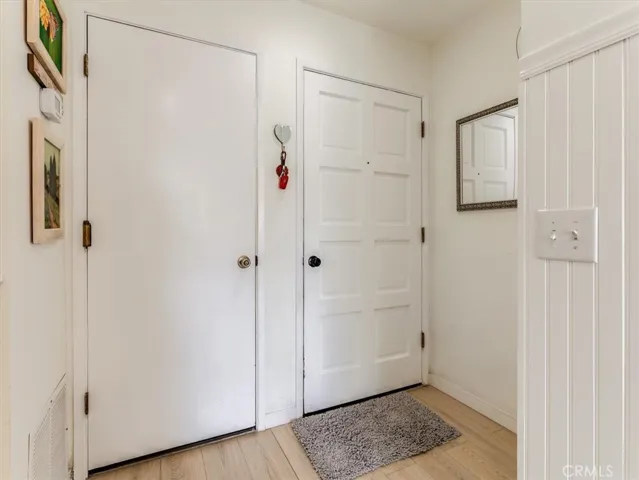 Inside of property showing front door and door to garage.