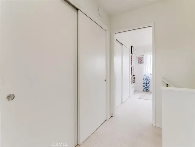 Upstairs view of closets and bedroom.