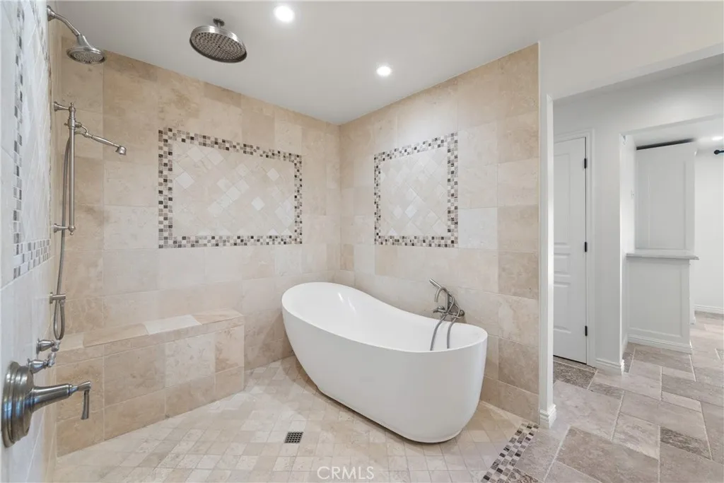 Rain shower and stand alone tub in primary bathroom