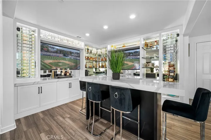 Bar area w/ plenty of custom shelving & cabinets